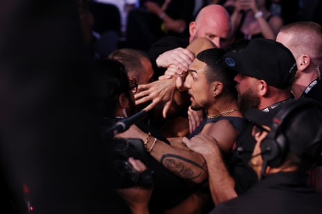 Teófimo López is restrained by security after Ryan Garcia's TKO victory over Conor Benn at T-Mobile Arena in Las Vegas.