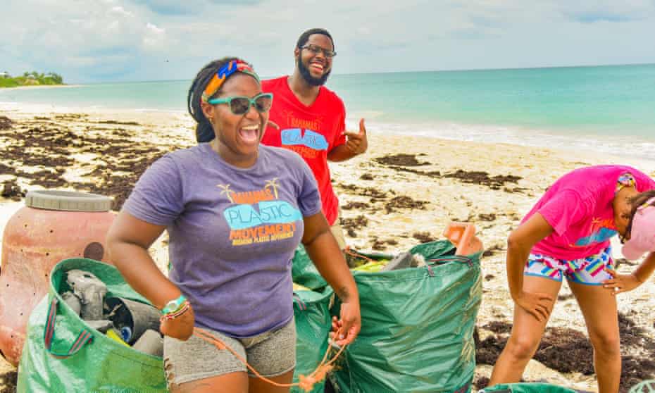 Kristal Ambrose (front) takes part in a beach cleanup
