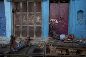 Labourers sleep in front of closed shops in Prayagraj, India