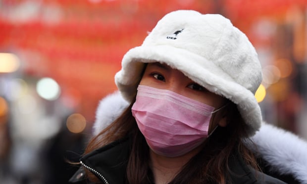 A woman wears a face mask in London