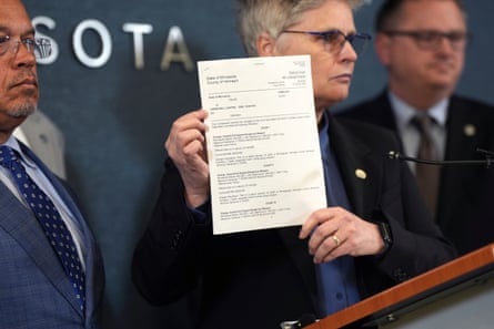 A state official holds up an official-looking document