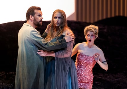 The Tenor and the Prima Donna clasp one another while Zerbinetta looks on