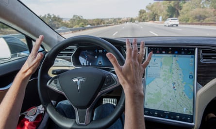 A driver with hands off the wheel in a Tesla.