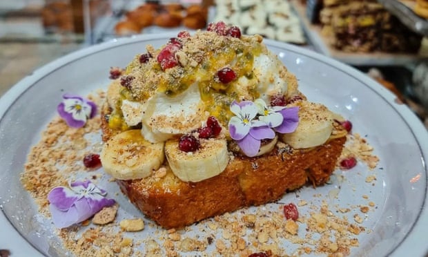 French toast topped with caramel banana, mascarpone and pomegranate seeds