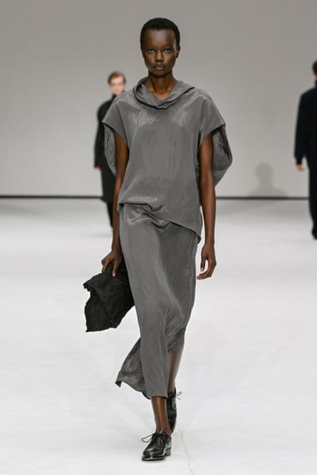 A model in a grey silky maxidress