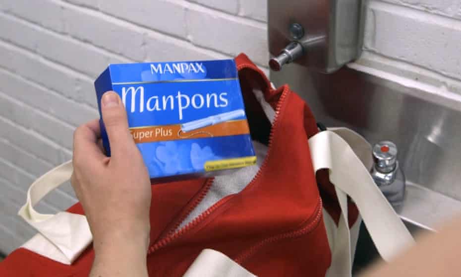 Hand holding packet of manpons