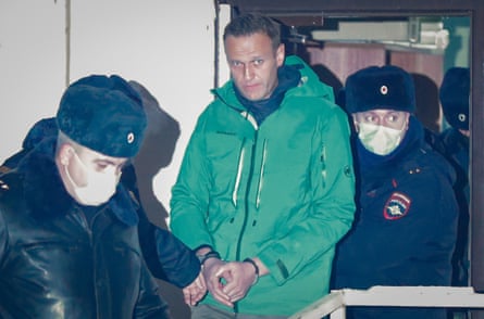 Alexei Navalny is escorted from a police station in Khimki in 2021.