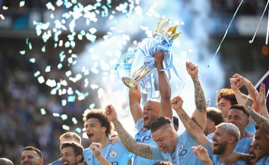 Vincent Kompany of Manchester City lifts the English Premier League Trophy as they celebrate becoming champions after beating Brighton & Hove Albion on May 12, 2019