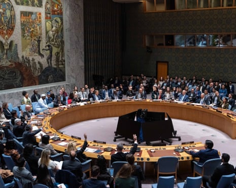 Members of the UN Security Council raise their hands to vote in favour of a draft resolution to authorise an International Stabilization Force in Gaza, on 17 November.
