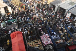 Traders gather at a fruit market in Lahore