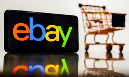 The eBay logo seen displayed on a smartphone along with a shopping cart.