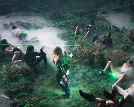 A group of people lying on the ground with green lasers shooting from their crotches