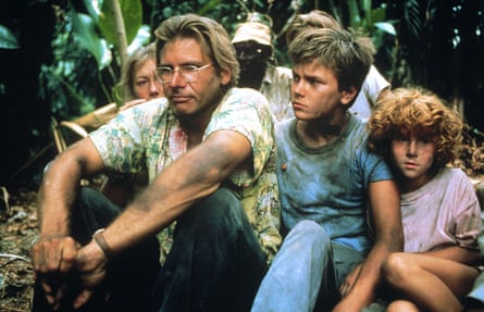 A family of four sitting in the jungle, from left, a blond woman, a man with glasses, a blond boy and a redheaded child.