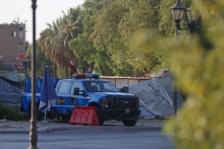 Iraqi security personnel in Baghdad in a blue flatbed truck in early morning