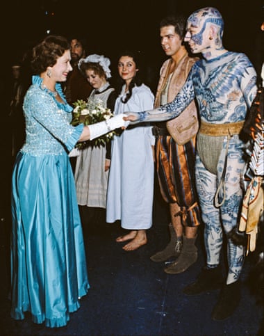 Queen, in a long dress and gloves, shakes the hand of a male ballet dancer at the Barbican in 1982