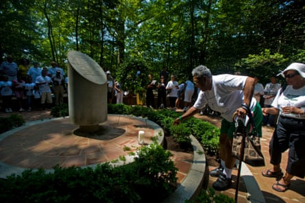 Followed by her daughter Ruth Lewis Shuler (right), Eunice Naomi Lewis puts leaves to the Salve Memorial to pay respect to her ancestors during The Quander family reunited at Mt. Vernon on 7 August 2010