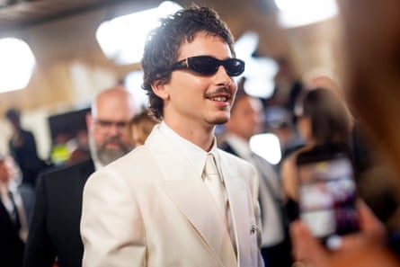 person wearing black sunglasses and white suit