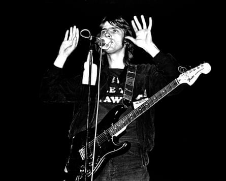 A black and white photo of Robyn Hitchcock performing with the Soft Boys