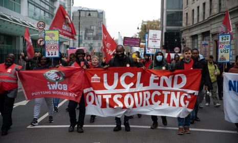 Striking workers march with a banner that says UCL end outsourcing