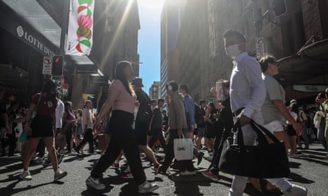 People walk in Sydney’s central business district