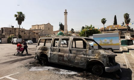 A burnt-out vehicle after violent confrontations in Lod.