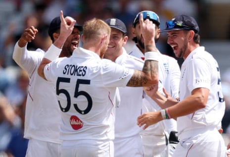 Ben Stokes celebrates the wicket of New Zealand's Mitchell Santner with teammates.
