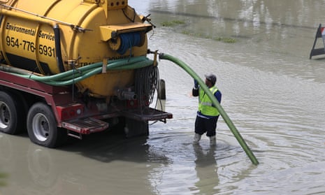 A worker uses a vacuum truck to suck up sewer water in Fort Lauderdale, Florida, on 24 February. 