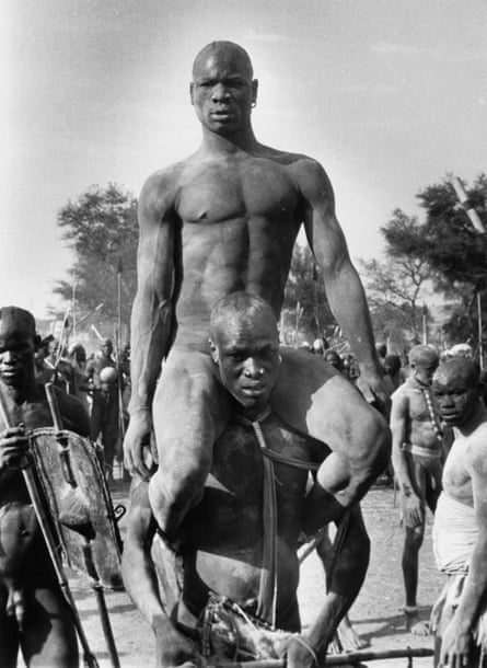 A Korongo Nuba Tribesman, Victor of a Wrestling Contest, sits on the shoulders of a friend.