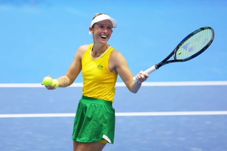 Storm Hunter smiles on court holding tennis balls and her racquet