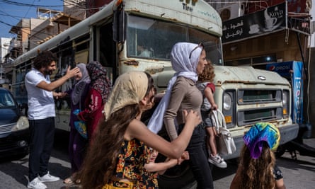 A mother and her five children cross a busy road in Tyre, Lebanon.