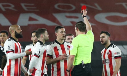Robert Jones shows Sheffield United’s Phil Jagielka the red card, after initially showing yellow before a VAR review