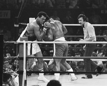 Muhammad Ali grimaces as he exchanges blows with Joe Frazier in the early rounds in Manila.