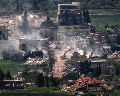Israeli army excavators demolish buildings in the southern Lebanese village of Mais al-Jabal, as seen from the Israeli side of the border, on Monday