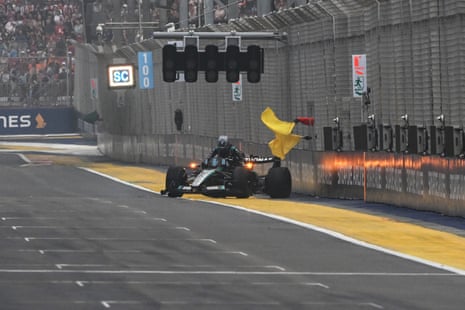 George Russell climbs out of his damaged car after a crash.