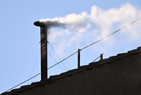 White smoke rises from the chimney on the Sistine Chapel, indicating that a new pope has been elected at the Vatican.