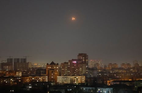 Explosions are seen in the sky over the city during a Russian drone strike, in Kyiv, Ukraine, on Friday evening.