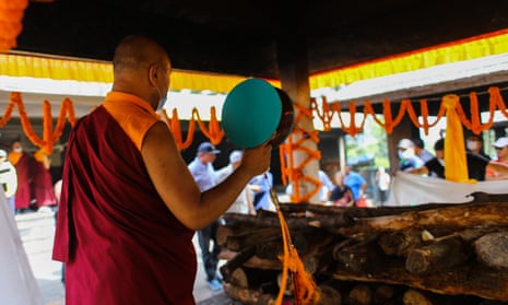 A monk performs rituals during the funeral of skier Hilaree Nelson in Kathmandu, Nepal.