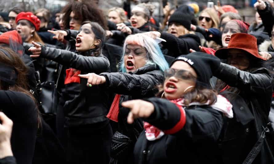 Women with blindfolds protest in front of the New York City criminal court on 10 January.