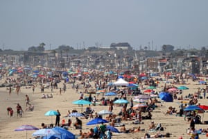 People gathering on the beach north of Newport Beach pier on 25 April.