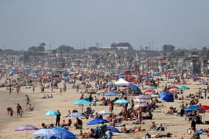 People gathering on the beach north of Newport Beach pier on 25 April.