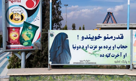 This photograph taken on 9 November 2022, shows a poster reading in Pashto, "Dear sisters! Hijab and veil are your dignity and are in your benefit in this world and in the hereafter", at the Habibullah Zazai Park on the outskirts of Kabul, Afghanistan.