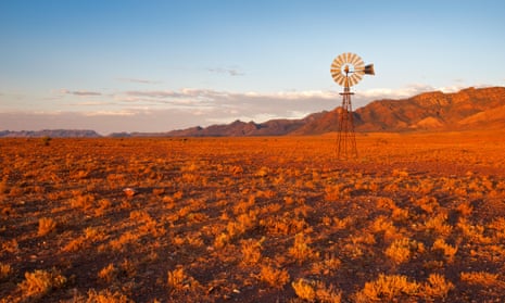 A windmill in the red hue of a sunset in Australia