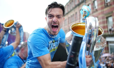 Jack Grealish during Manchester City’s bus parade on Monday, holding the Champions League trophy.