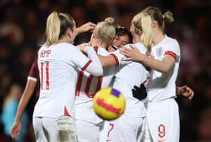 Jess Carter is mobbed after scoring the eleventh goal for England.