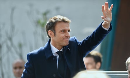 Emmanuel Macron waves to a crowd