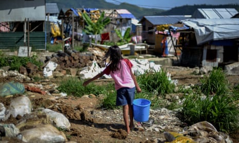 A girl makes her way home after fetching water at a coastal village in Tacloban, Leyte province.