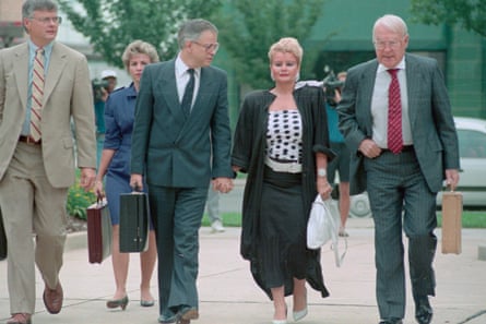 Jim Bakker and Tammy Faye hand in hand with others around