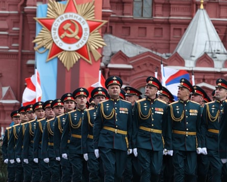 Columns of uniformed Russian service personnel march in Red Square