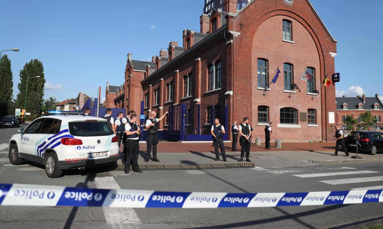 Officers secure the area around a police building in Charleroi, Belgium.