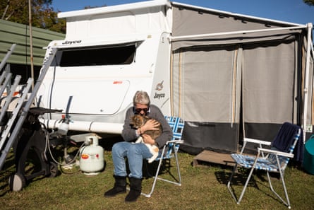 Kay Armour, her cat Zari and the caravan where she and her husband are living.